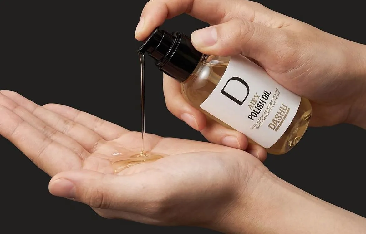 A few drops of DASHU Pro Airy Polish Oil pumped into an open palm