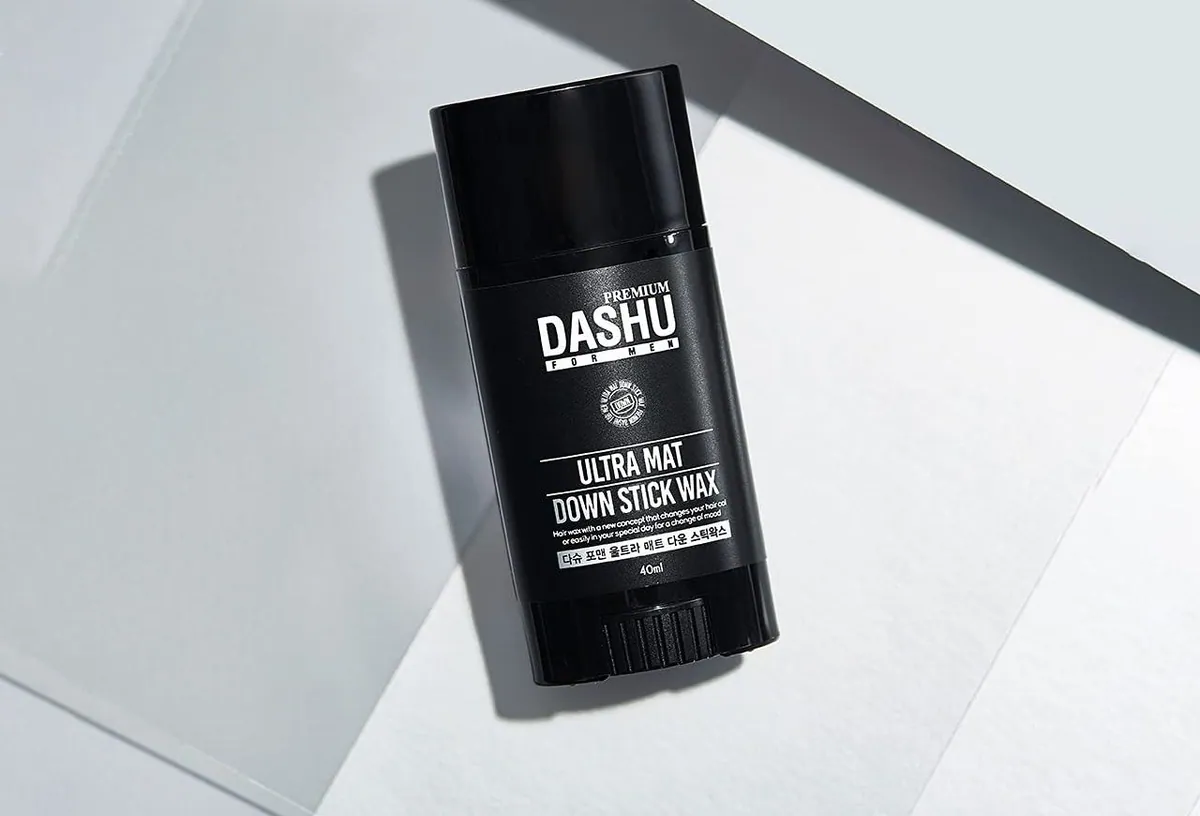 A black DASHU Ultra Mat Down Stick Wax standing on a light surface